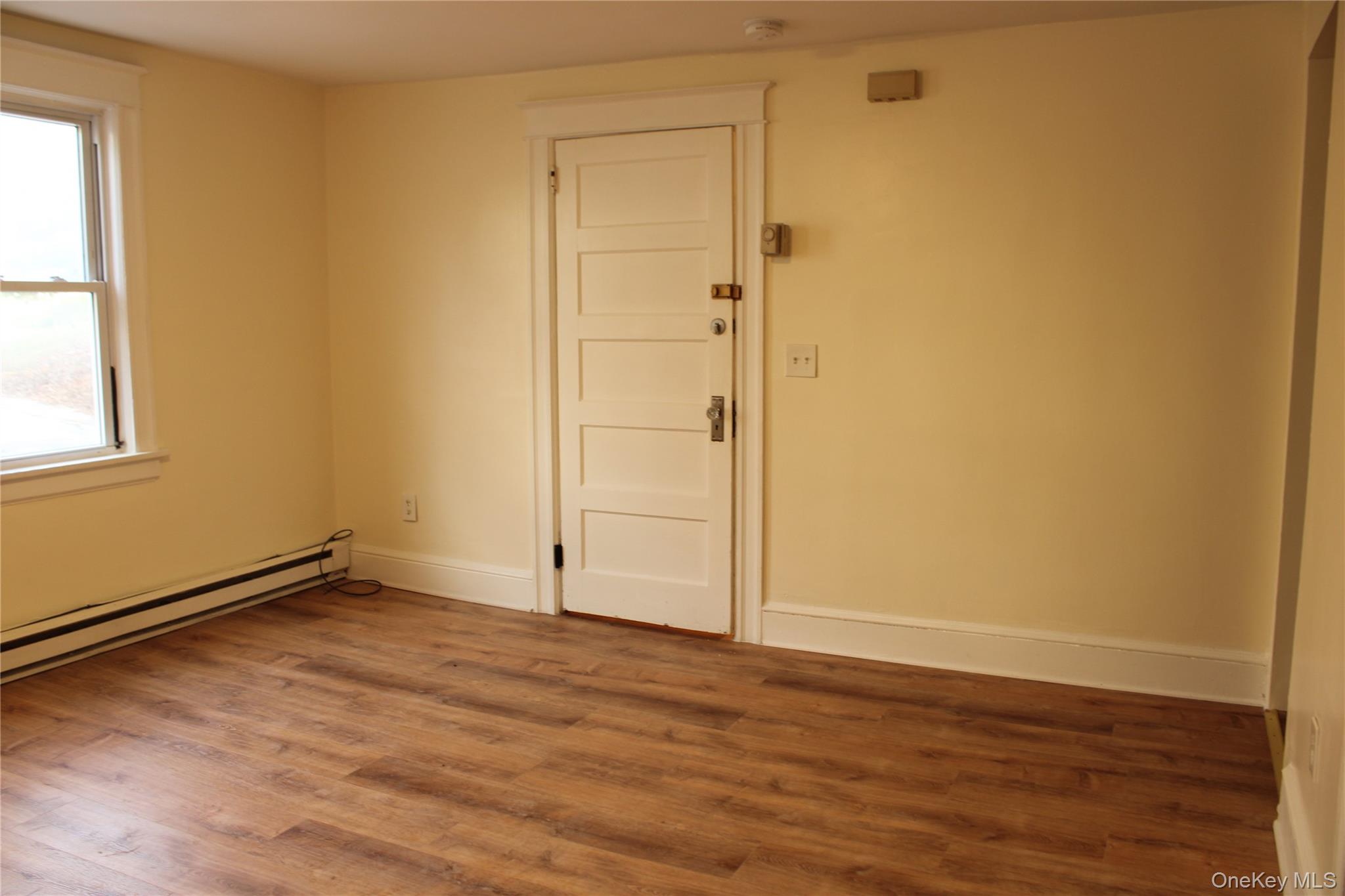 52 South Bridge Street, Unit 1 Poughkeepsie, NY 12601 - Photo 7 of 27 an empty room with wooden floor and windows