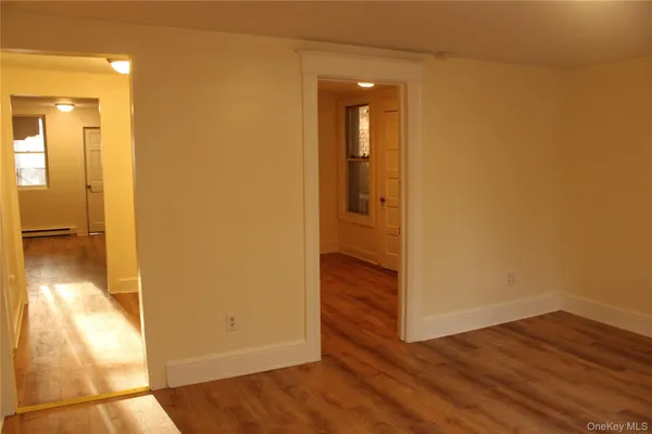 a view of a hallway with wooden floor