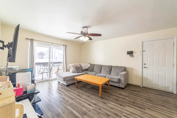a living room with furniture and wooden floor