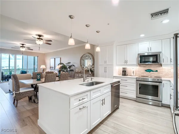 a living room with furniture and a large window with balcony view