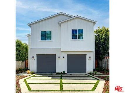 a kitchen with stainless steel appliances granite countertop a stove a sink dishwasher a dining table and chairs with wooden floor