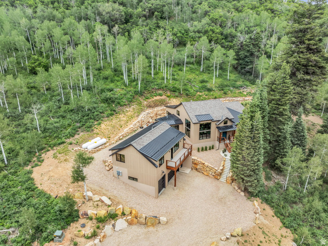 1766 West Tollgate Cyn Road Coalville, UT 84017 - Photo 47 of 59 Modern mountain residence featuring a multi-level design, gravel driveway, and a natural stone retaining wall