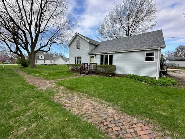 a front view of house with yard and green space