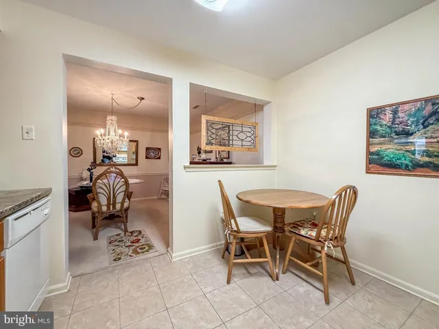 a bedroom with a bed and a dresser with rug