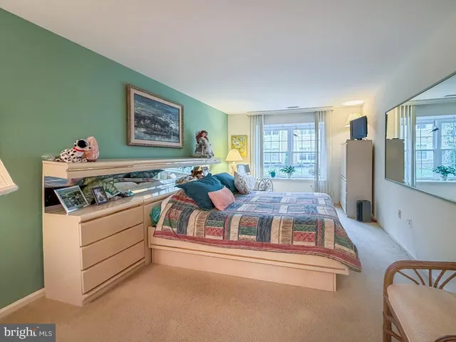 a living room with a bed furniture and a large window