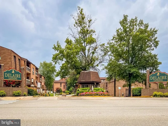 a front view of a building with tree s
