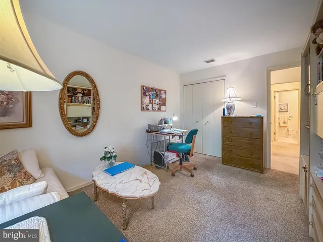 a bathroom with a granite countertop sink and a toilet