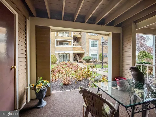 a backyard of a house with deck and outdoor seating