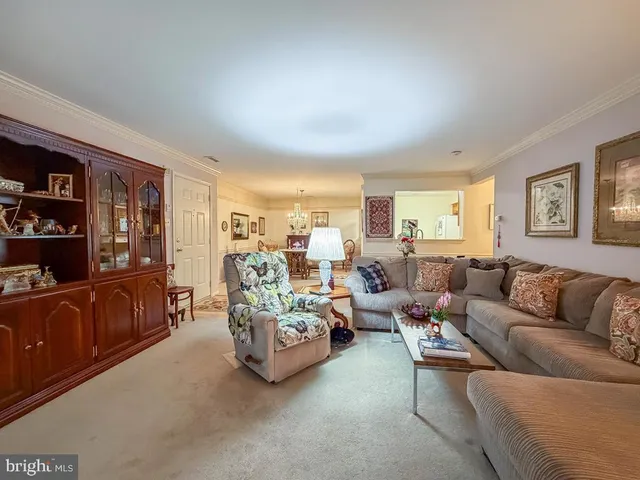 a living room with furniture and large windows