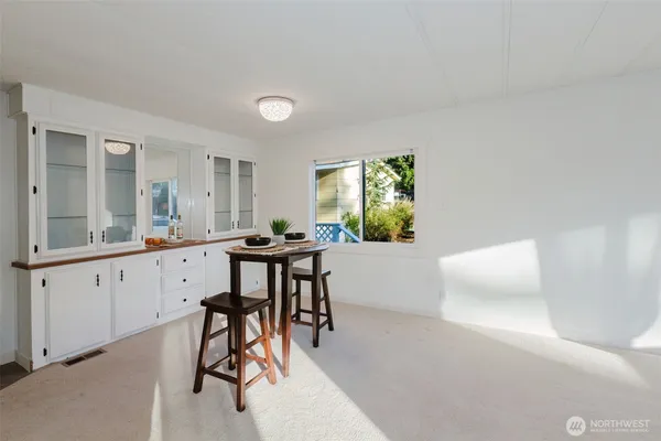 a view of dining room with wooden floor and furniture