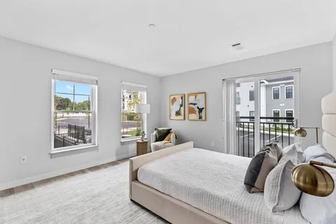 a bedroom with a large bed and a window