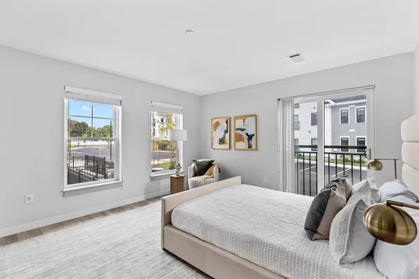 a bedroom with a large bed and a window
