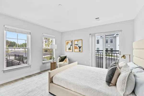 a bedroom with a large bed and a window