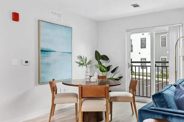 a dining room with furniture and wooden floor