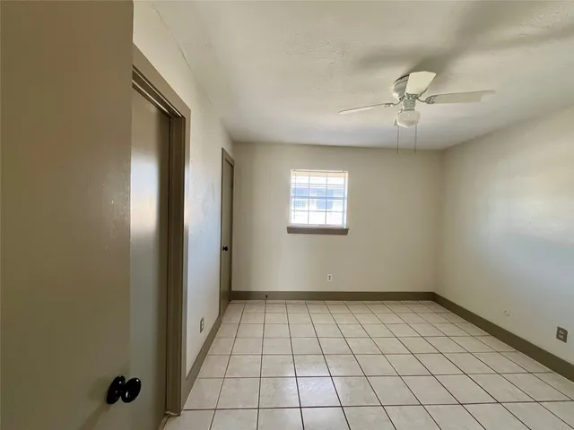 a view of an empty room and a window