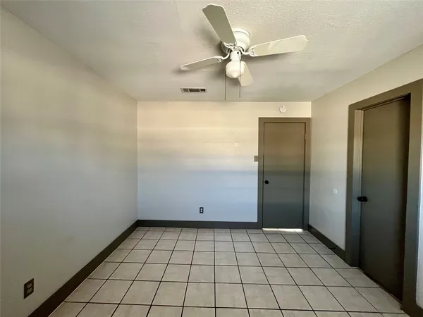an empty room with white walls and tiles