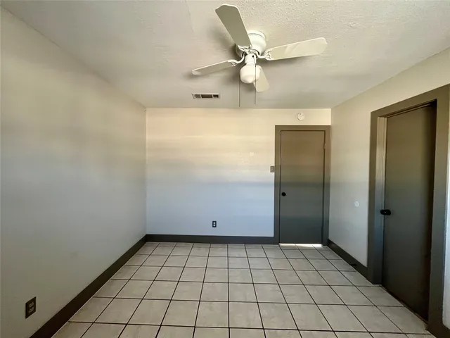 an empty room with white walls and tiles