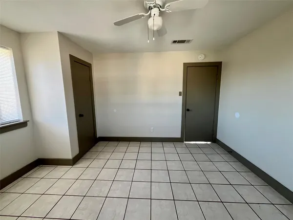 an empty room with windows and closet