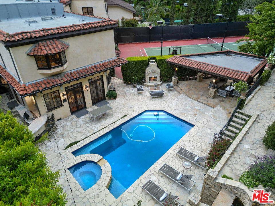 an aerial view of a house with balcony and patio