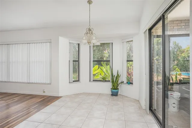 a view of an entryway with wooden floor and a livingroom view