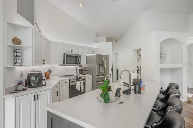 a kitchen with sink a stove and cabinets