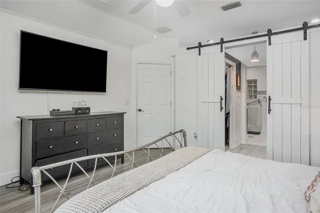 a bedroom with a bed and a flat screen tv