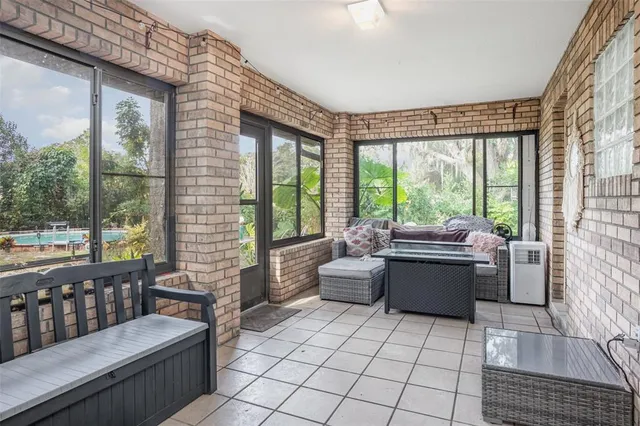 a living room with furniture and large windows