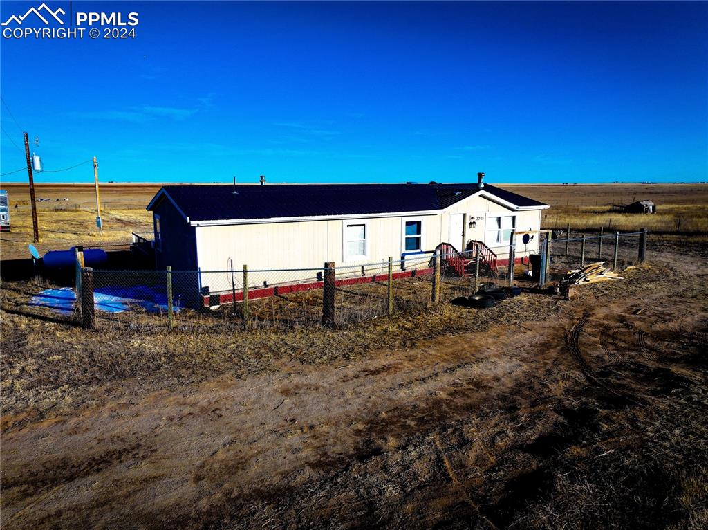 3705 South Johnson Road Rush, CO 80833 - Photo 17 of 31 a view of a house with a yard