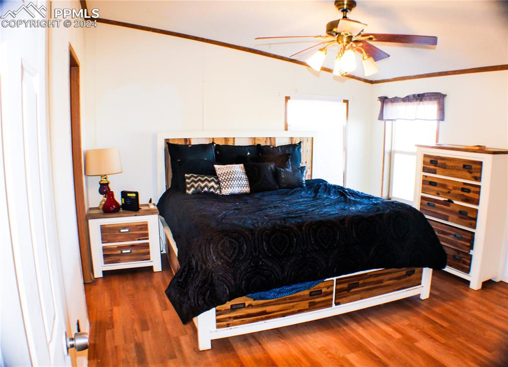 3705 South Johnson Road Rush, CO 80833 - Photo 8 of 31 a bedroom with a bed and a chandelier