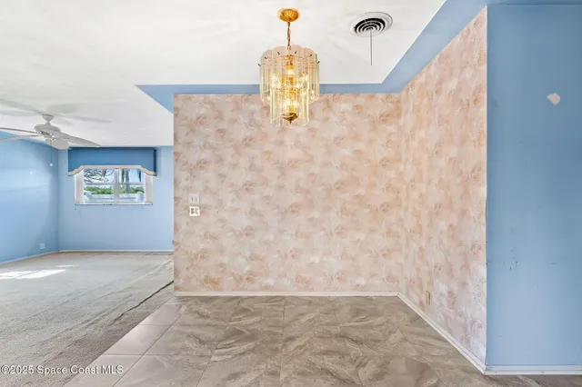 a view of an empty room with windows