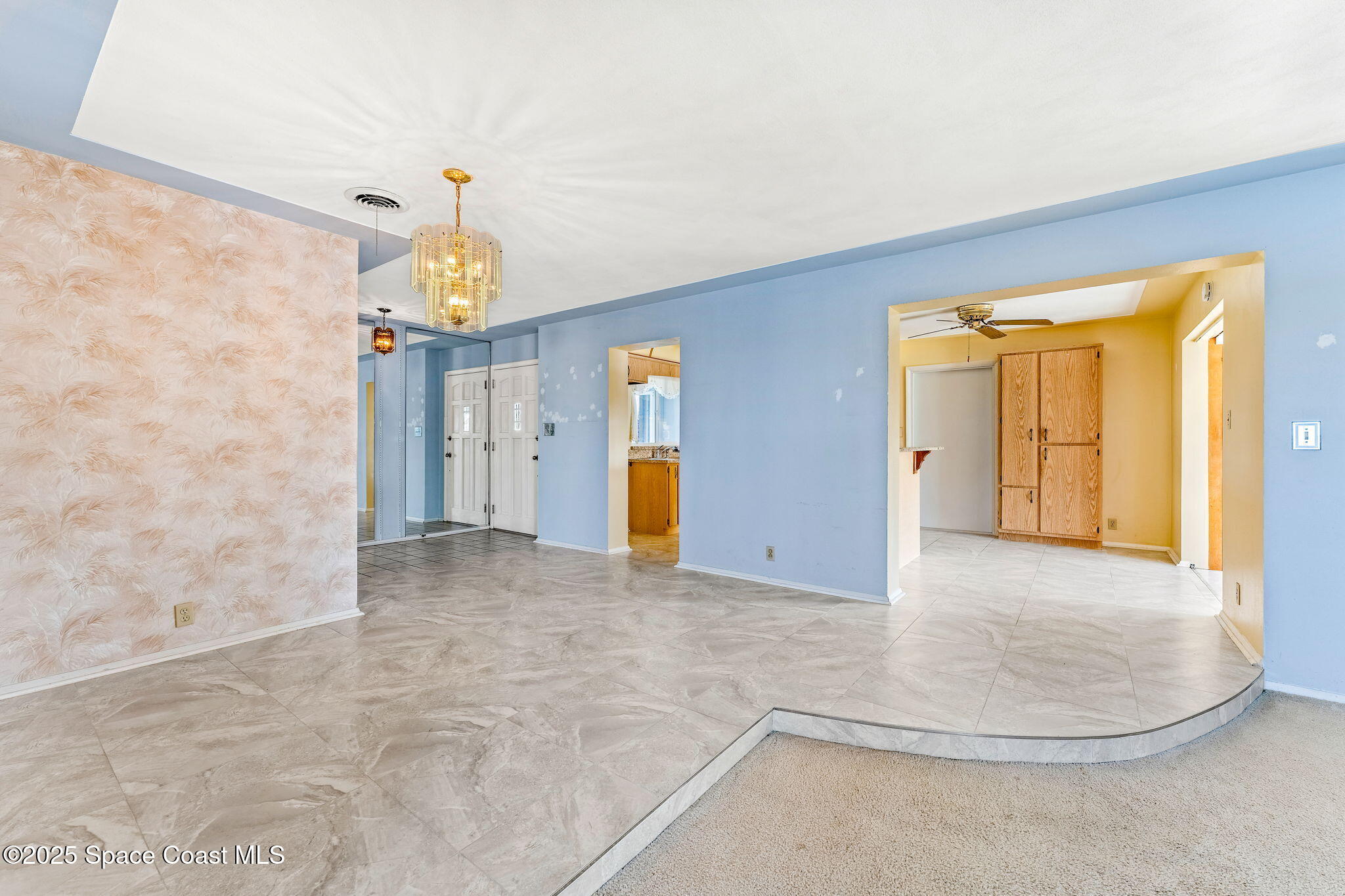 272 Bahama Boulevard Cocoa Beach, FL 32931 - Photo 15 of 63 a view of a livingroom with wooden floor and a ceiling fan