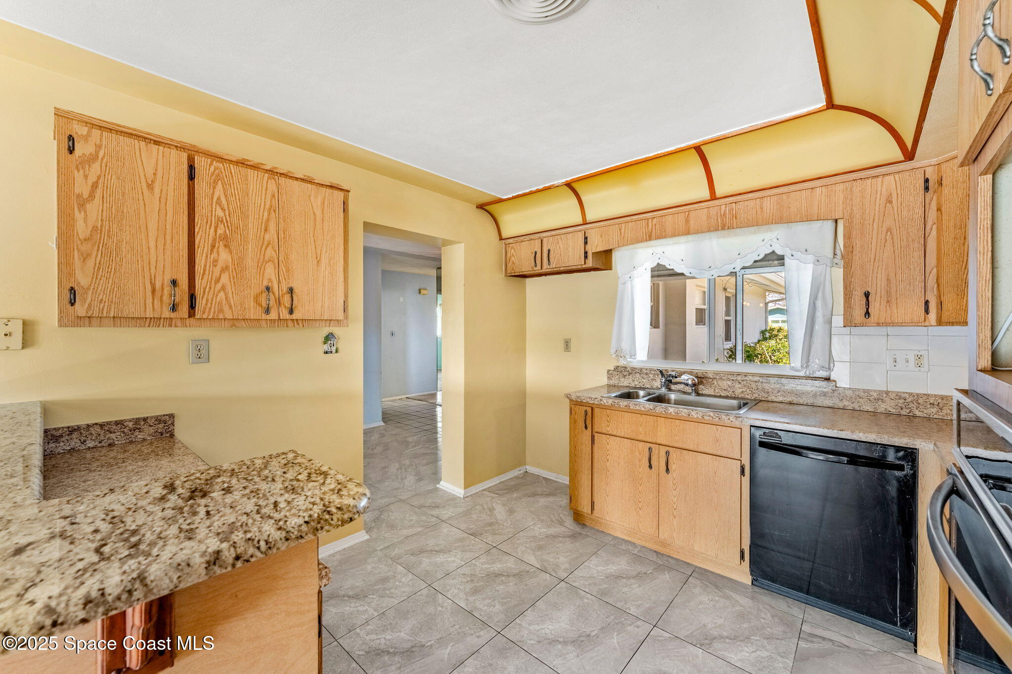 272 Bahama Boulevard Cocoa Beach, FL 32931 - Photo 18 of 63 a bathroom with a granite countertop sink a mirror and a bathtub
