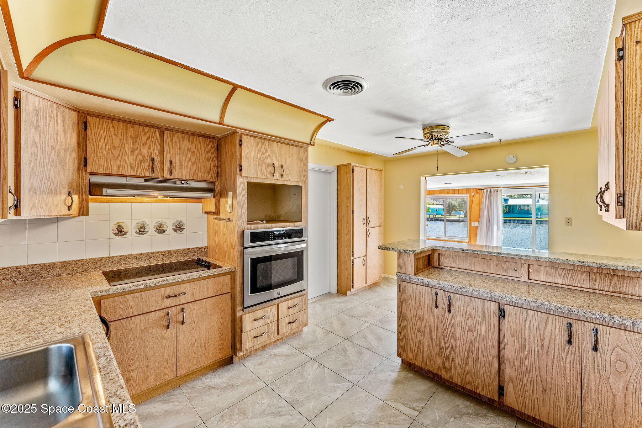 272 Bahama Boulevard Cocoa Beach, FL 32931 - Photo 19 of 63 a kitchen with granite countertop cabinets stainless steel appliances and a sink