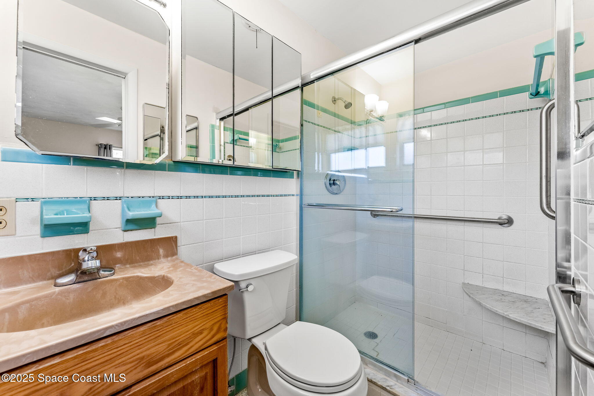 272 Bahama Boulevard Cocoa Beach, FL 32931 - Photo 29 of 63 a bathroom with a sink a toilet and shower