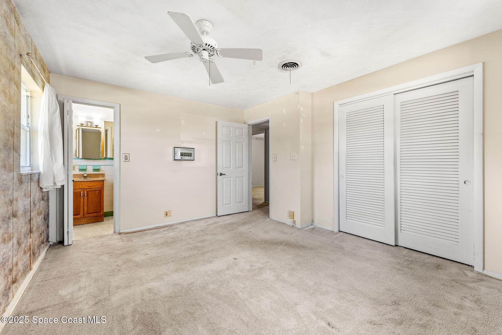 272 Bahama Boulevard Cocoa Beach, FL 32931 - Photo 30 of 63 an empty room with closet and a ceiling fan
