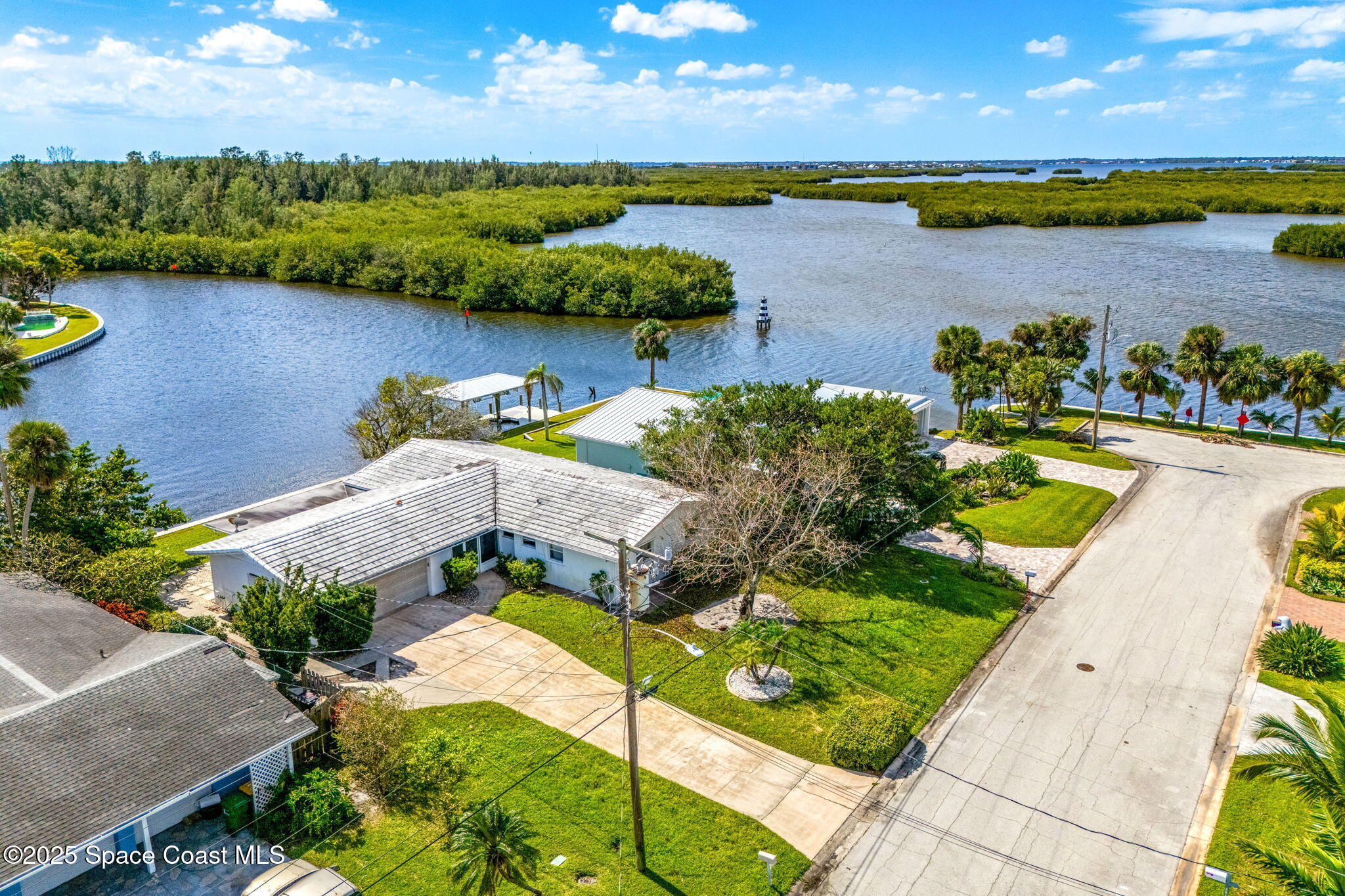 272 Bahama Boulevard Cocoa Beach, FL 32931 - Photo 50 of 63 an aerial view of a house with a lake view