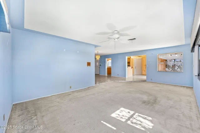 a spacious bathroom with a granite countertop sink a mirror and a bath tub