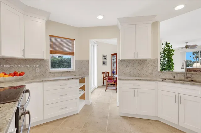 a view of swimming pool with outdoor seating and house in the background