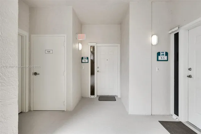 an empty room with closet and a bathroom