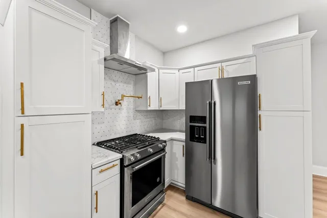 a bathroom with a granite countertop sink a toilet and shower
