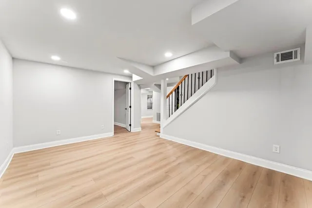 a view of a room with wooden floor and stairs