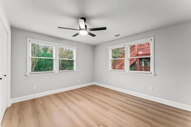 a view of an empty room and wooden floor