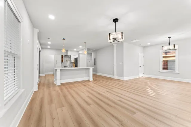 a view of a kitchen with wooden floor and a sink