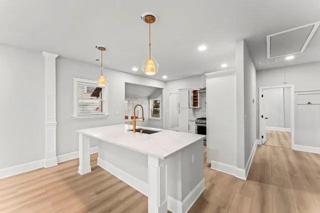 a view of a kitchen counter space and wooden floor