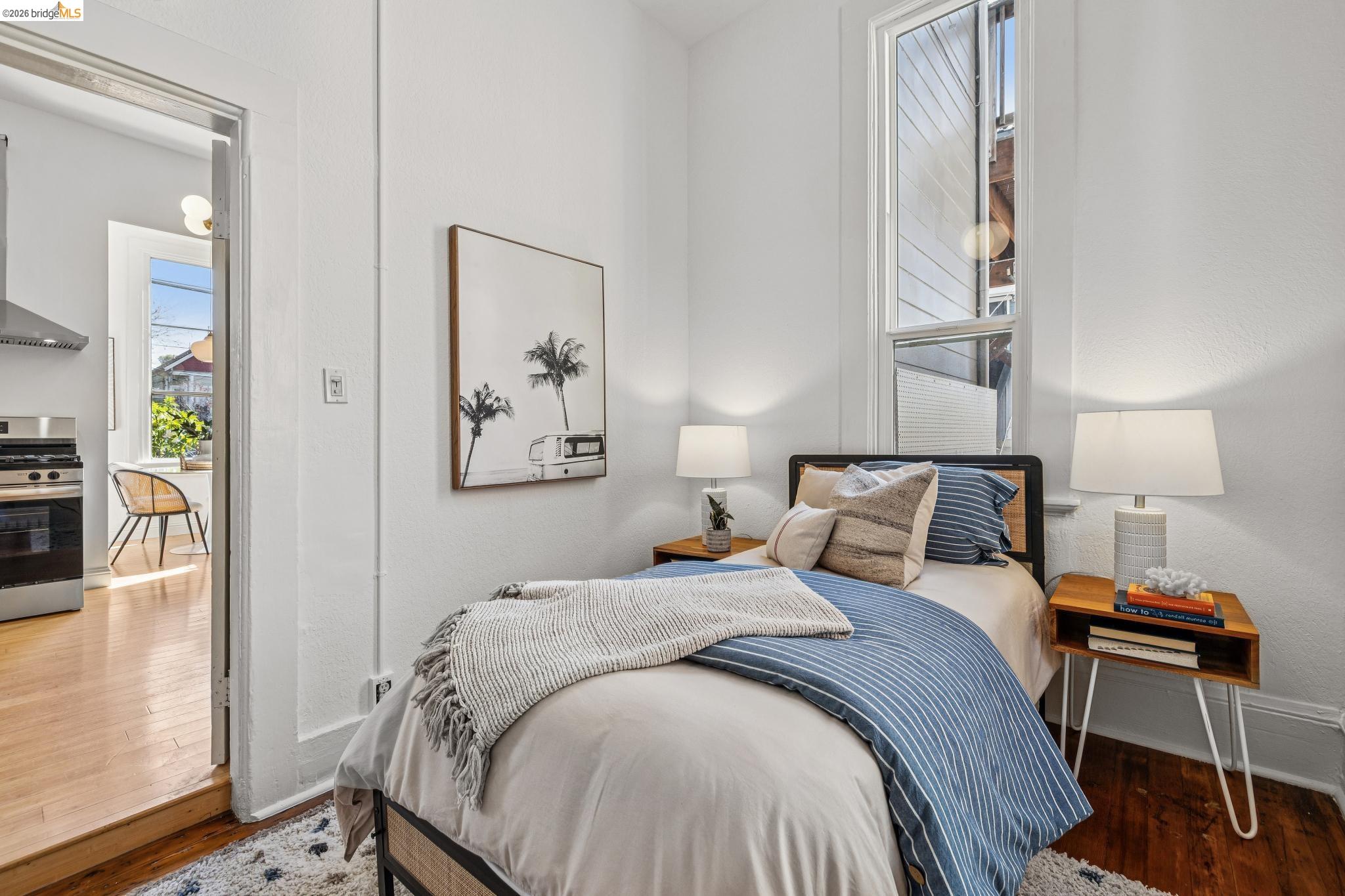 1655 12th Street Oakland, CA 94607 - Photo 19 of 51 a bed room with a bed and a painting on the wall