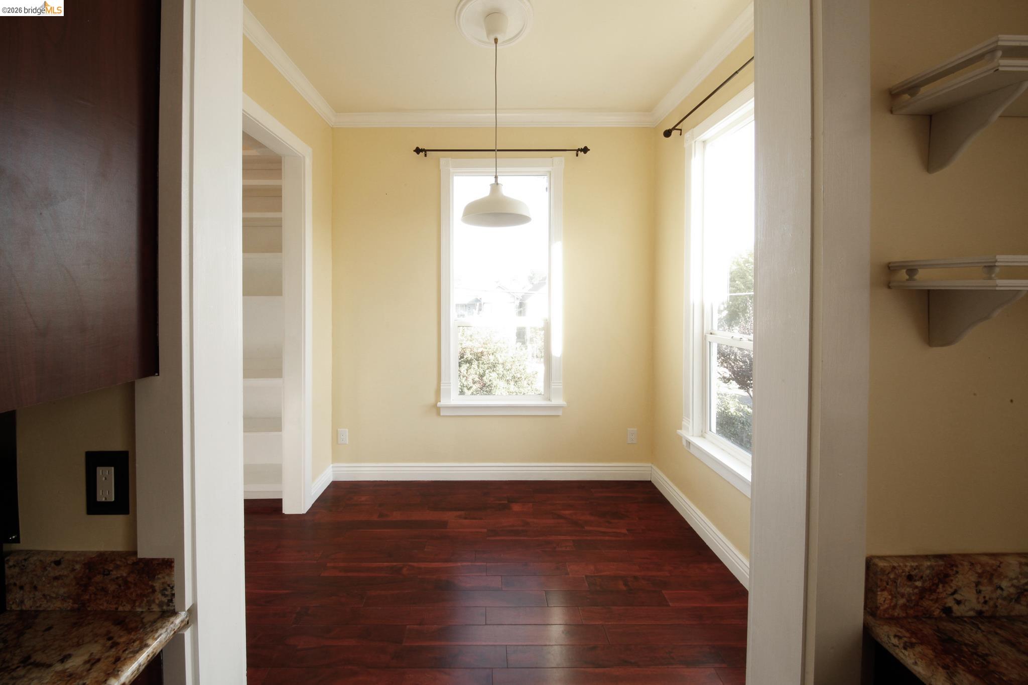 1655 12th Street Oakland, CA 94607 - Photo 40 of 51 a view of an empty room with wooden floor and a window
