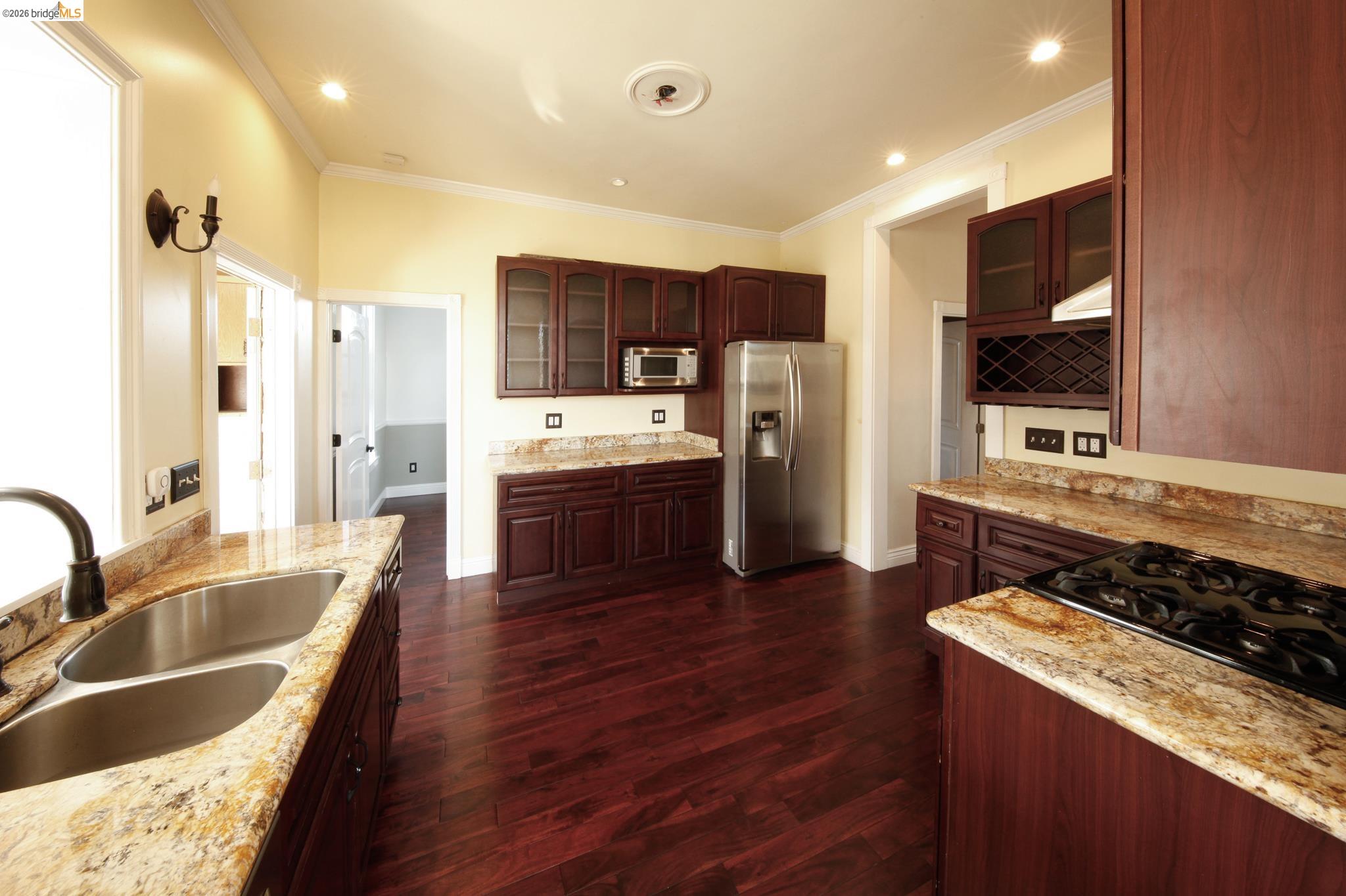 1655 12th Street Oakland, CA 94607 - Photo 42 of 51 a kitchen with stainless steel appliances granite countertop a sink stove and refrigerator