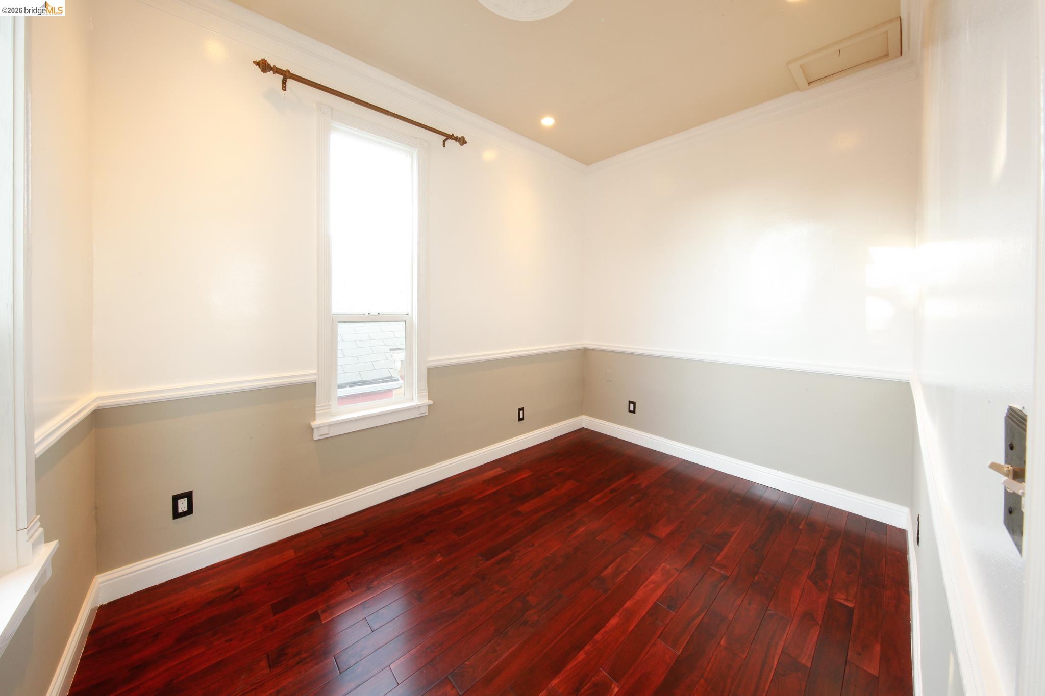 1655 12th Street Oakland, CA 94607 - Photo 45 of 51 a view of an empty room with wooden floor and a window