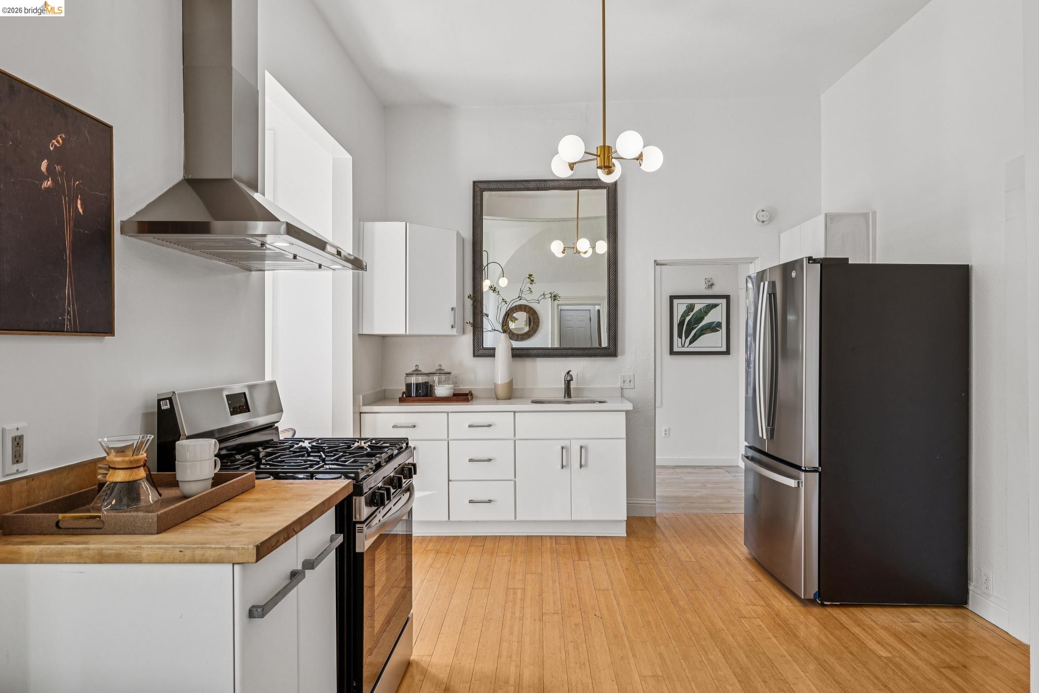 1655 12th Street Oakland, CA 94607 - Photo 7 of 51 a kitchen with a refrigerator sink and stove