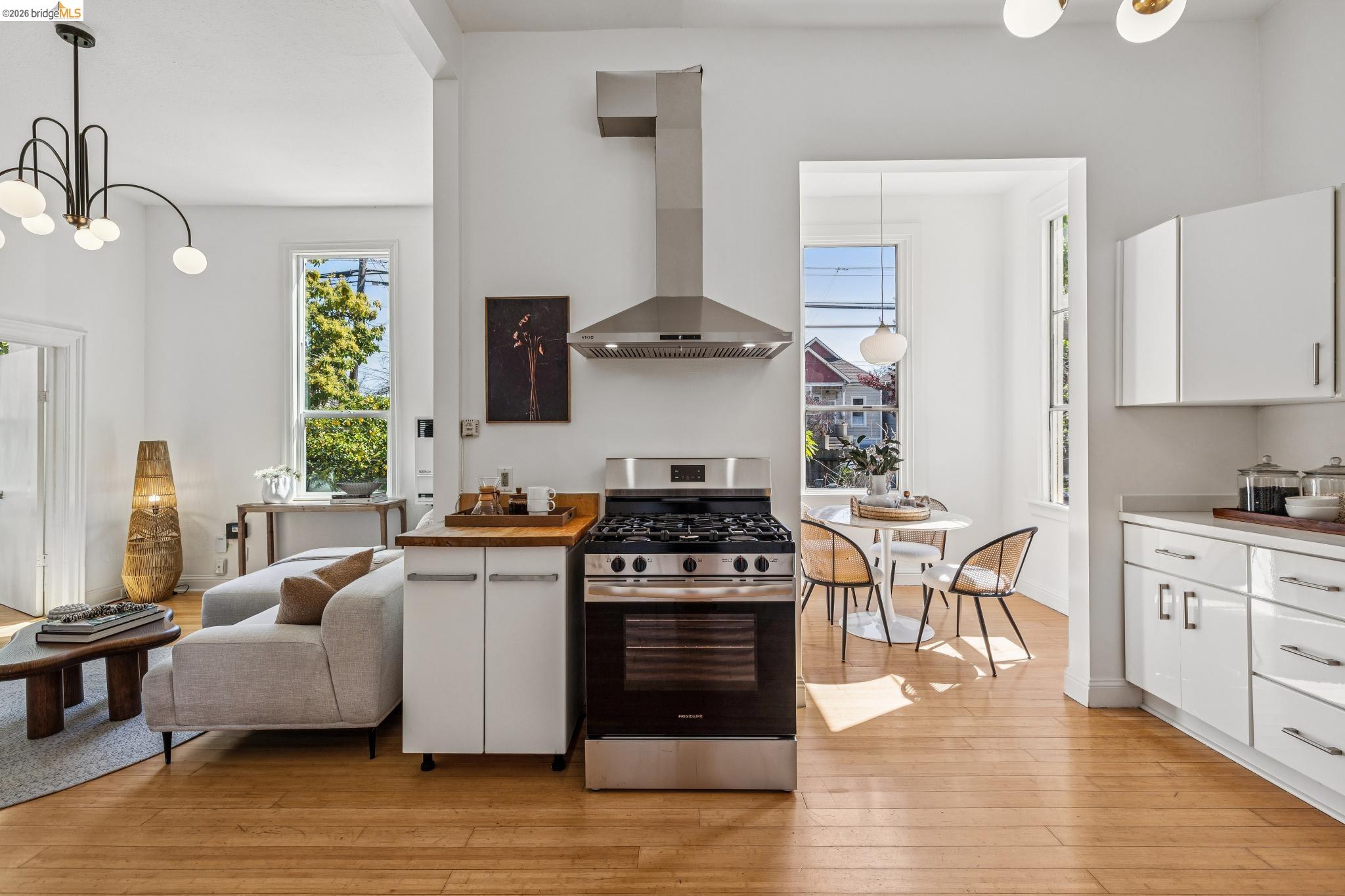 1655 12th Street Oakland, CA 94607 - Photo 8 of 51 a kitchen with stainless steel appliances granite countertop a stove and white cabinets